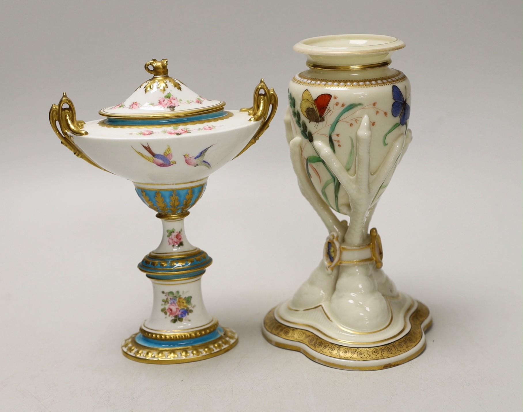 A Royal Worcester urn, modelled as three birds legs holding an oviform vase and a Royal Crown Derby two handled urn and cover on stand, Worcester urn 17cms high
